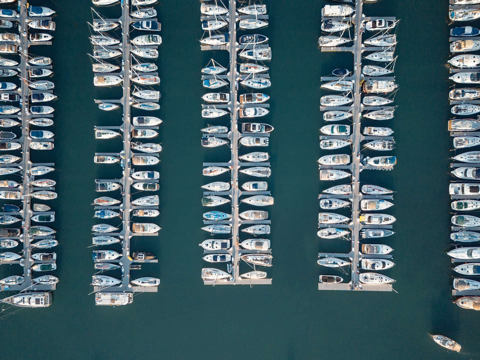 Aerial view of organized marina slips and docked boats