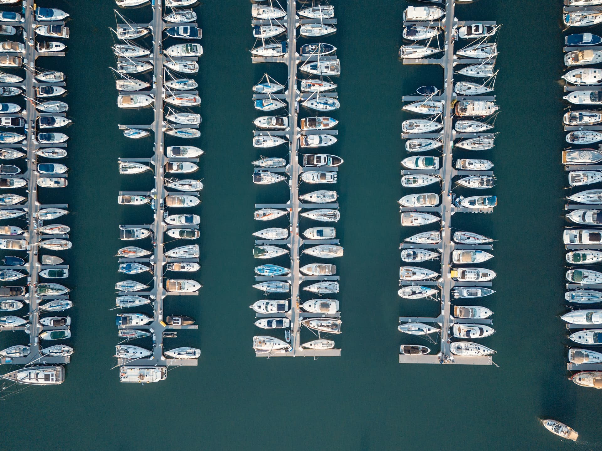 Aerial view of organized marina slips and docked boats