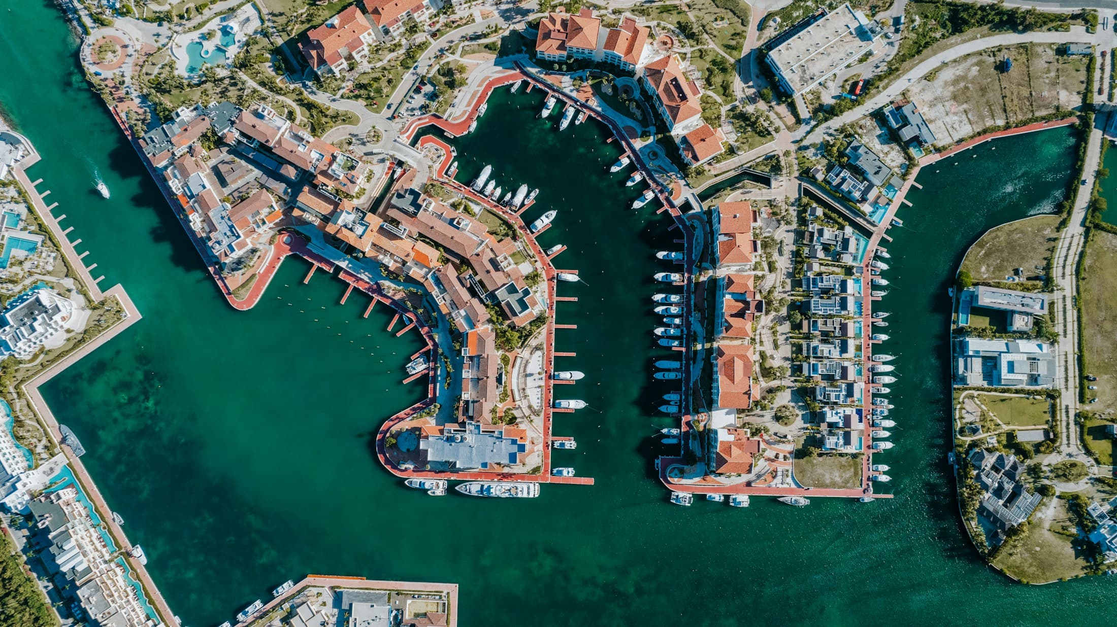 Aerial view of a marina with boats and waterfront buildings
