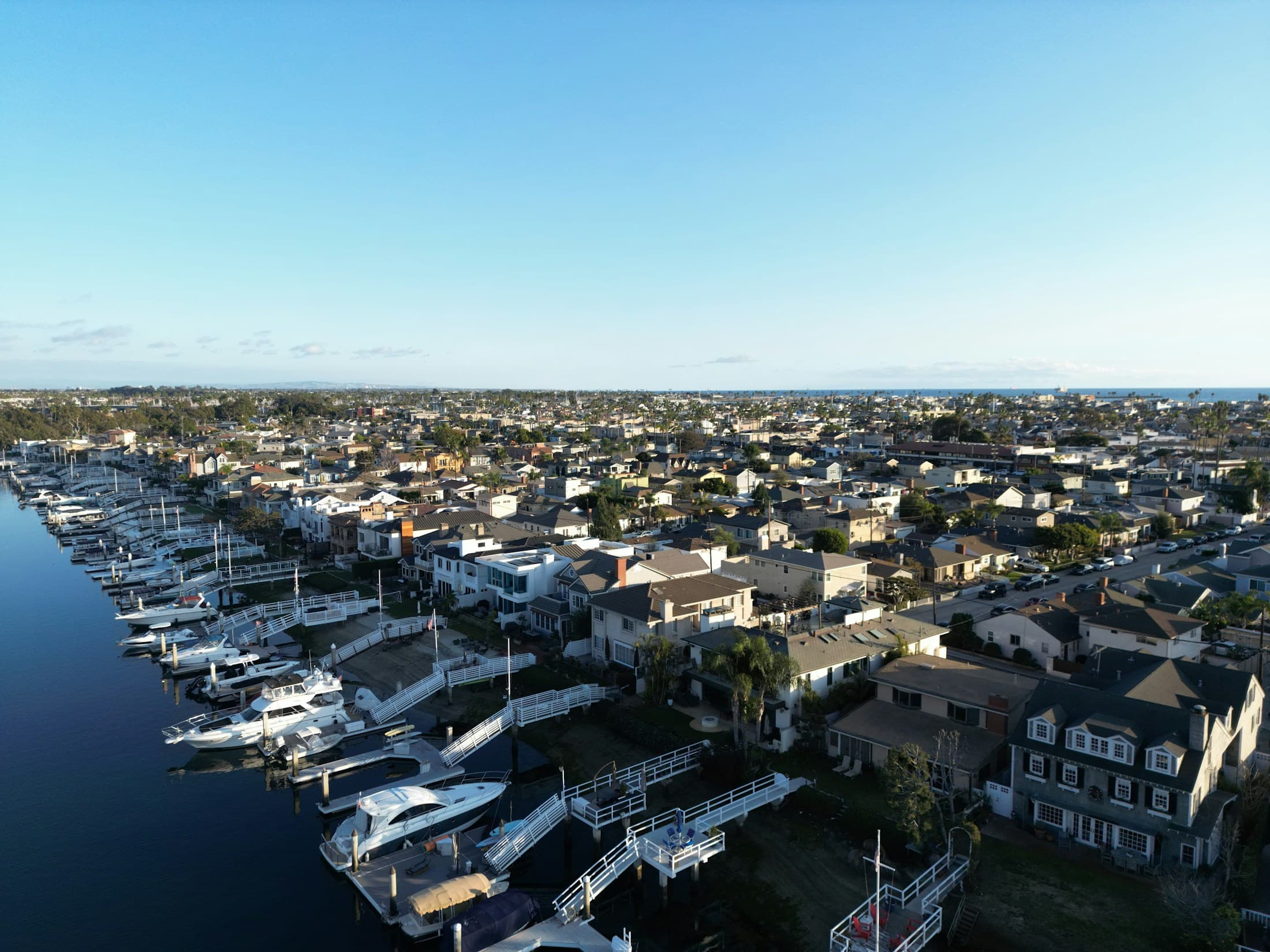 Aerial view of boats docked in a marina with clear organized slips