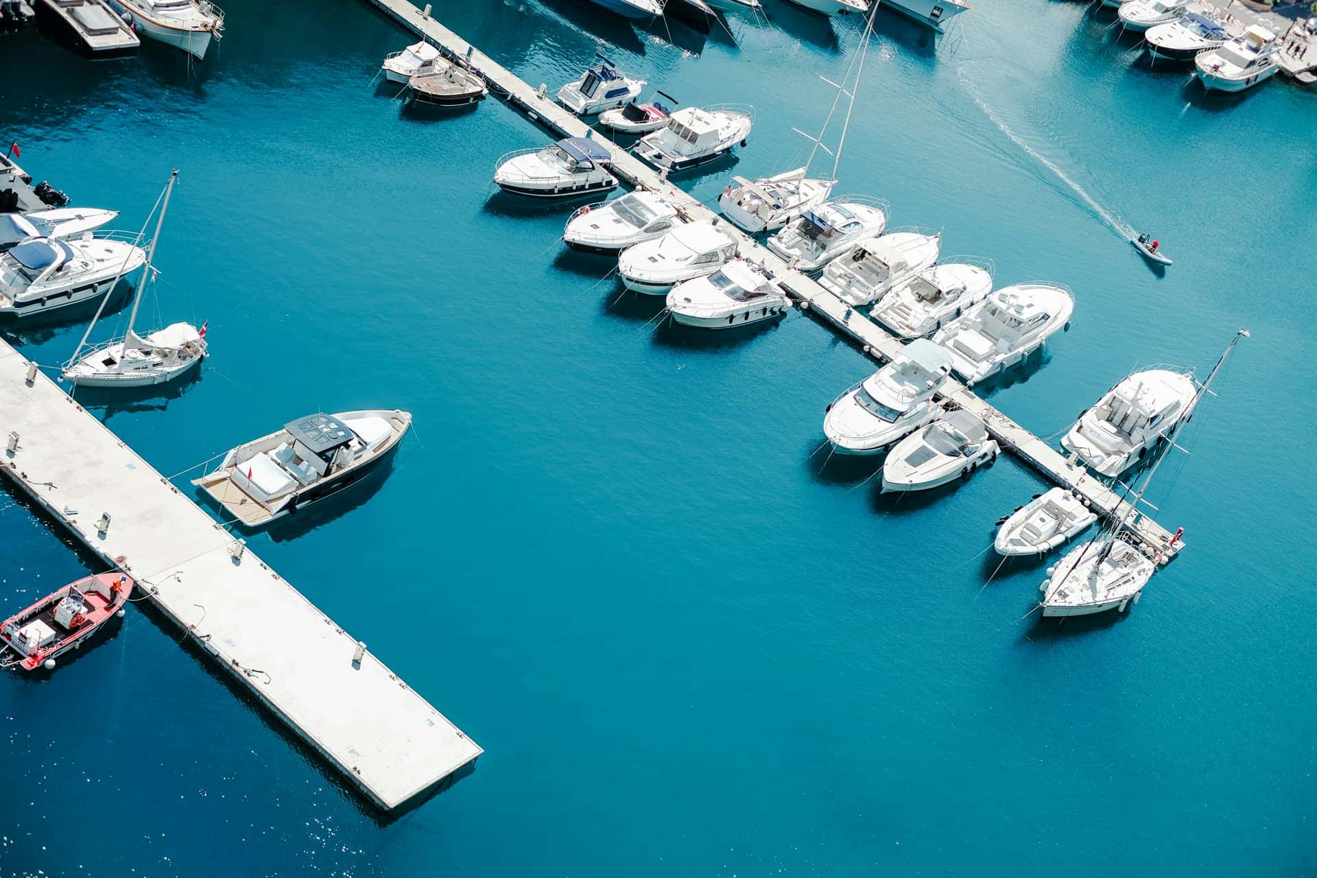 Aerial view of a marina with boats docked along the piers