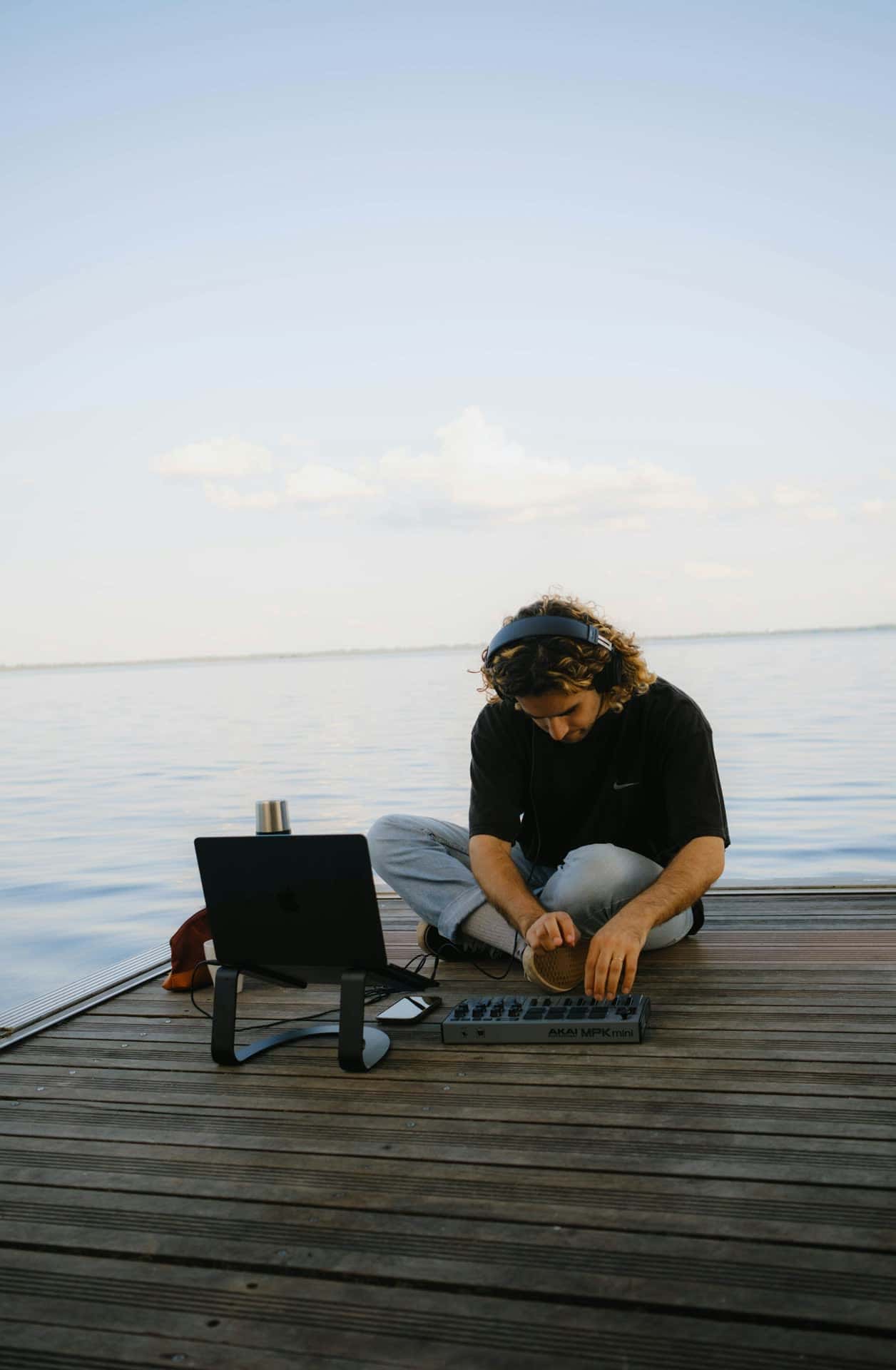 Person evaluating marina software on a laptop near the water